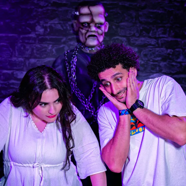 Two startled players with a chained monster looming behind them in Magic Potion
